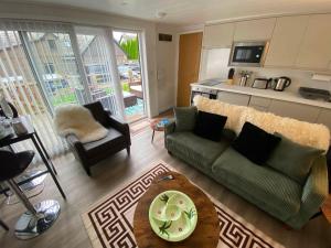 a living room with a couch and a table at Balmaha Lodges and Apartments in Balmaha