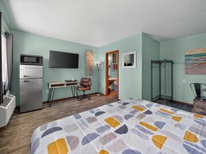 a hotel room with a bed and a desk at Clara City Inn in Clara City
