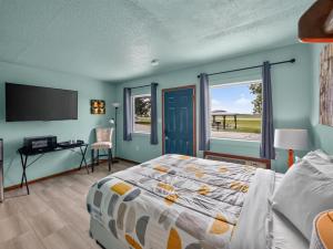 a bedroom with a bed and a desk and a window at Clara City Inn in Clara City