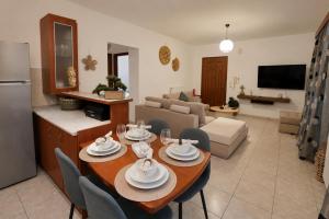 a kitchen and living room with a table and chairs at Indaba Luxury Apartments in Myrina