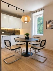 a dining room with a table and four chairs at Le Mas d'Elio in Cheval-Blanc