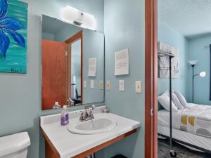 a bathroom with a sink and a mirror and a bed at Clara City Inn in Clara City +63 photos