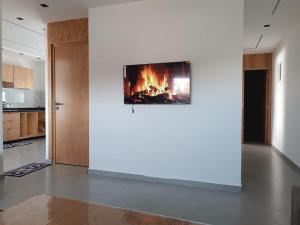 a living room with a fire on the wall at BlueSea Studio's &Appart in Oualidia