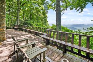 a wooden deck with benches and a view of the mountains at Blue View Chalet in Blowing Rock
