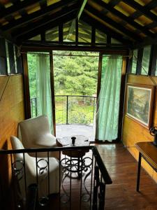 a room with a table and chairs and a large window at Centro Holístico Kinam in Amecameca de Juárez