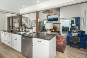 a kitchen with white cabinets and a blue couch at Blue View Chalet in Blowing Rock