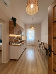 a kitchen with a sink and a counter at Hedera Home in Komárno