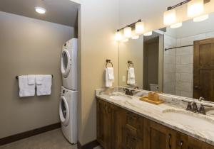 a bathroom with a sink and a washing machine at Cana Loft 301 in Whitefish