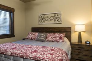 a bedroom with a bed with a wooden head board at Cana Loft 301 in Whitefish +10 photos