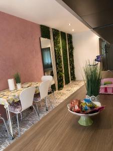 a dining room with a table and white chairs at Apartman Bambi Vlašić in Vlasic +5 photos