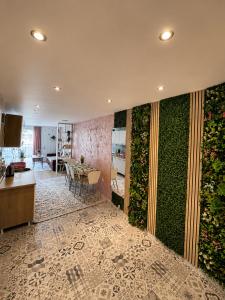 a living room with a green wall and a table at Apartman Bambi Vlašić in Vlasic