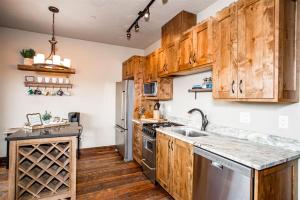 a kitchen with wooden cabinets and stainless steel appliances at Cana Loft 302 in Whitefish