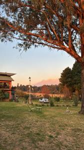 a park with a car parked in a field at Centro Holístico Kinam in Amecameca de Juárez