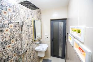 a bathroom with a shower and a toilet and a sink at Résidence Acharif in Tan-Tan Plage +43 photos
