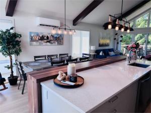 a kitchen and living room with a candle on a counter at Kaïros - Private Spa & Golf Getaway in Saint-Basile