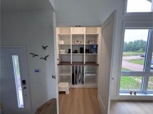 a room with white shelves and a window at Kaïros - Private Spa & Golf Getaway in Saint-Basile