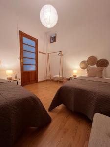 a bedroom with two beds and a large window at Apartamento Carmen in Macastre +30 photos