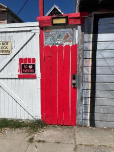 a red door on a building with a no parking sign at Cottage Bed 1 at FacesOasis in Oakland