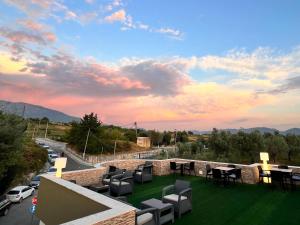 a view of a patio with chairs and tables at Jata Hotel in Tirana