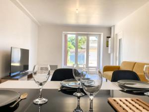a dining room with wine glasses on a table at La Maison du Clain in Jaunay-Clan