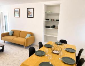 a living room with two tables and a couch at La Maison du Clain in Jaunay-Clan +2 photos