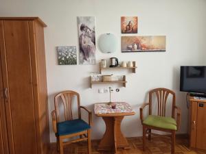 a room with two chairs and a table and a tv at Cozy Nook Stays near Rogla & Terme Zreče in Zreče