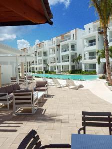 a large building with chairs and a swimming pool at Bora 102 Garden Breeze 1 in La Laguna