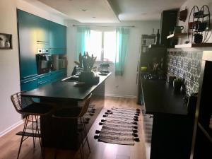a kitchen with a large black island in a room at Villa Stella in Montauban