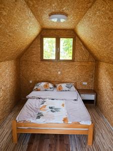 a bed in a small room in a house at TreeHouse Experience in Vusanje