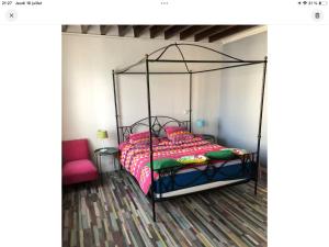 a bedroom with a bed with a metal frame at Le nid marin in Étretat