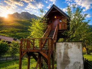 a tree house on a wooden platform with the mountains in the background at TreeHouse Experience in Vusanje