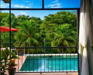 a view of a swimming pool from a window at Casa Esperanza in Playa Estacahuite +23 photos