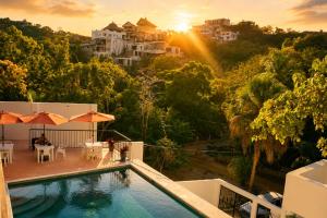 a villa with a swimming pool on top of a house at Casa Esperanza in Playa Estacahuite