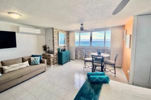 a living room with a couch and a table at KASA Emmas Ocean View in San Juan