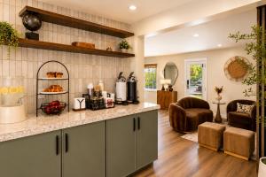 a kitchen with a counter and a living room at Wayside Inn in Carmel