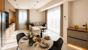 a kitchen and living room with a table and chairs at Villa Lancana in Zvekovica
