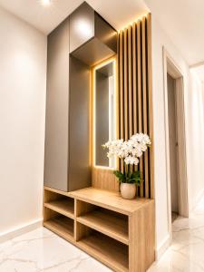 a dressing room with a mirror and a vase of flowers at Villa Lancana in Zvekovica