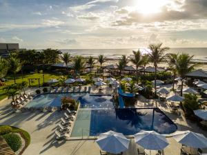 an aerial view of a resort with a pool and the ocean at Hotel Praia do Sol in Ilhéus