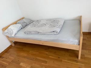 a bed in a room with a wooden frame at Malmi Home in Vaasa