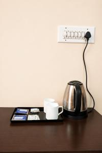 a table with a tea kettle and a coffee pot at Mahal Rajwada-A Heritage Resort in Jaipur