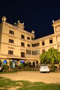 a white car parked in front of a large building at Mahal Rajwada-A Heritage Resort in Jaipur