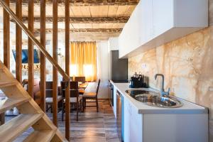 a kitchen with a sink and a dining room at VILA K3 Komarnica in Šavnik