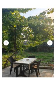 a picnic table and two chairs in a park at Old Rooms in Sheki +20 photos