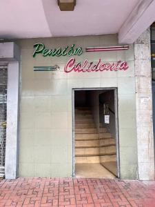 a entrance to a building with stairs and a sign at Pension Calidonia in Panama City