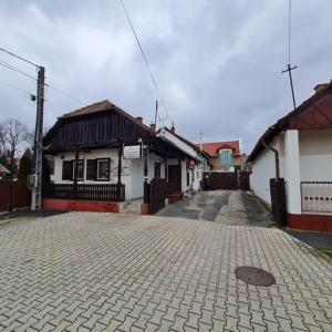a cobblestone street in a town with buildings at Pitvar Vendégház in Zalaegerszeg