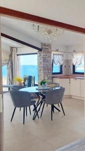 a kitchen and dining room with a table and chairs at Villa Stone House Poplat in Vela Luka