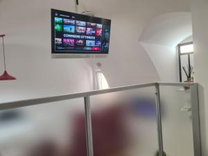 a flat screen tv hanging on a wall at Horizon Suite Bellavista in Catanzaro
