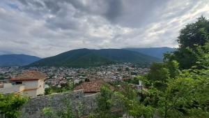 a view of a city with mountains in the background at Old Rooms in Sheki