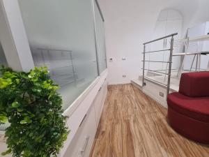 a room with a red staircase and a plant at Horizon Suite Bellavista in Catanzaro