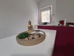 a statue of a woman sitting on top of a fountain at Horizon Suite Bellavista in Catanzaro